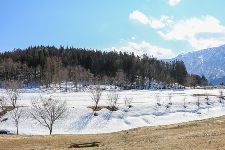 Hakuba mountain range    in the winter with snow on the mountain and blue sky and clouds background in Hakuba  Nagano Japan.の写真素材