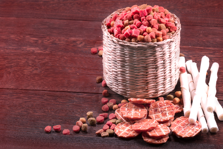 Dog snack ,dog dood, dog chews, dog biscuits on a grey wooden table wall background with copy space .の写真素材