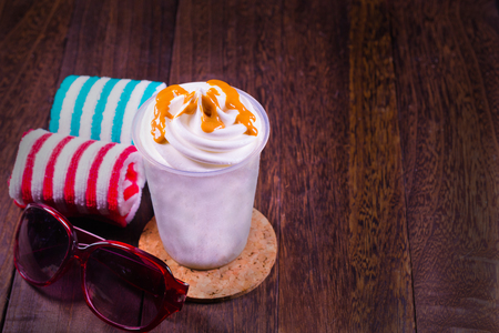 Chocolate ice cream in a cup sunglasses on a grey wooden table wall background with copy space .の写真素材