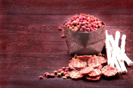 Dog snack ,dog dood, dog chews, dog biscuits on a grey wooden table wall background with copy space .の写真素材