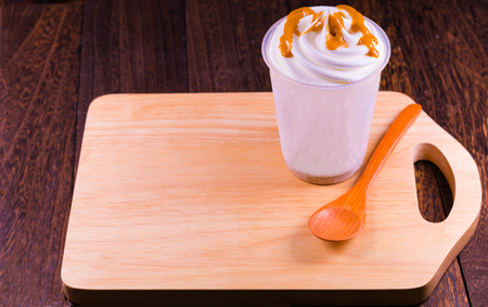 Chocolate ice cream in a cup on a grey wooden table wall background with copy space .の写真素材