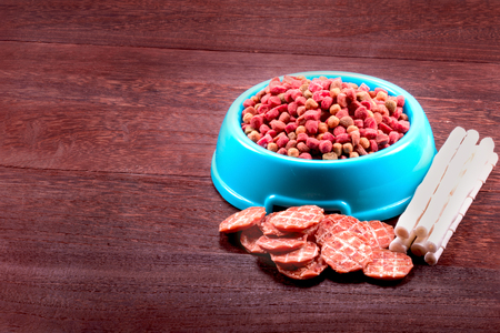 Dog snack ,dog dood, dog chews, dog biscuits on a grey wooden table wall background with copy space .の写真素材