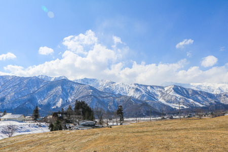 Hakuba mountain range   in the winter with snow on the mountain and blue sky and clouds background in Hakuba  Nagano Japan.の写真素材