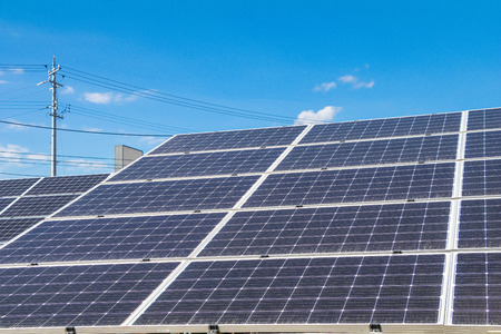 Solar  power panels for innovation green energy for life with mountains and blue sky background.の写真素材