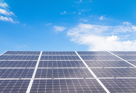 Solar  power panels for innovation green energy for life with mountains and blue sky background.の写真素材