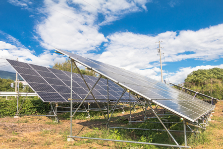 Solar  power panels for innovation green energy for life with mountains and blue sky background.の写真素材