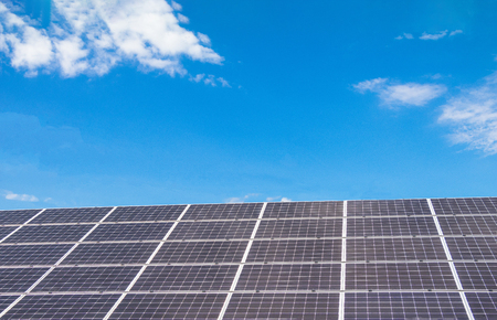 Solar  power panels for innovation green energy for life with mountains and blue sky background.の写真素材