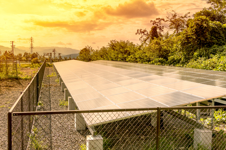 Solar  power panels for innovation green energy for life with mountains and blue sky background.の写真素材