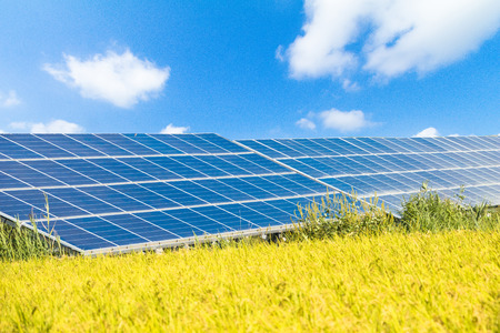 Solar  power panels for innovation green energy for life with mountains and blue sky background.の写真素材