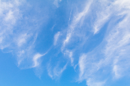 Clear blue sky background with white clouds.の写真素材