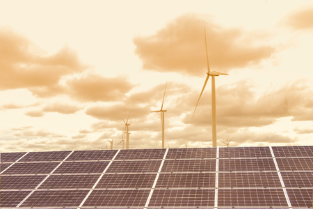 Solar power panels ,Photovoltaic modules for innovation green energy for life  and wind turbines against with blue sky background .の写真素材