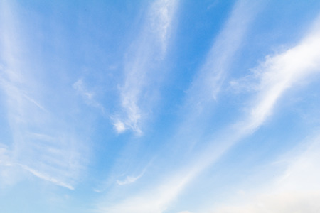 Clear blue sky background with white clouds.の写真素材