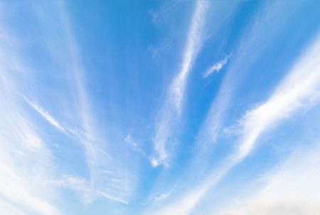 Clear blue sky background with white clouds.の写真素材