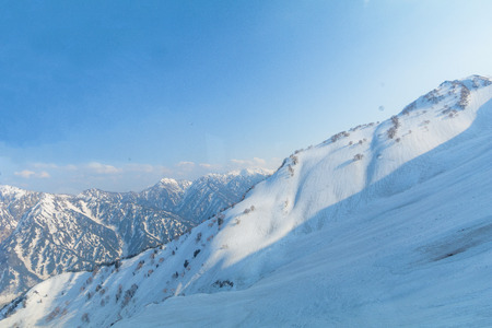 The snow mountains of Tateyama Kurobe alpine  with blue sky  background is  one of the most important and popular natural place in Toyama Prefecture, Japan.の写真素材