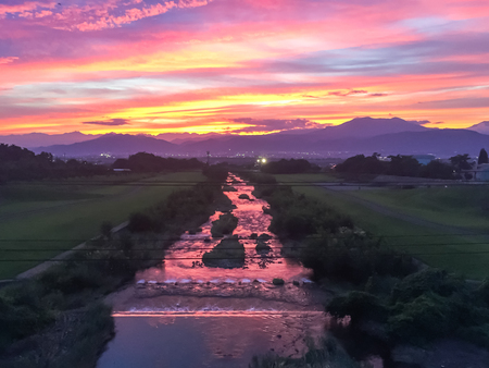 Beautiful  sunset and sun rays with colorful of  sky background over the  river .の写真素材