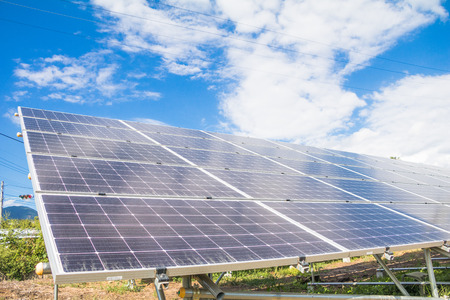 Solar  power panels for innovation green energy for life with mountains and blue sky background.の写真素材