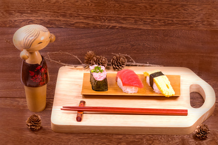 Japanese food ,sushi with chopsticks on wooden table wall background .の写真素材