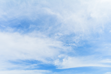 Clear blue sky background with white clouds.の写真素材