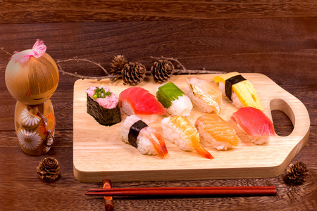 Japanese food ,sushi with chopsticks on wooden table wall background .の写真素材