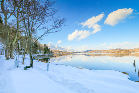 Beautiful fresh snow in winter around the mountains  Lake ,and tree  with blue sky  background, Nagano Prefecture, Japan.の写真素材