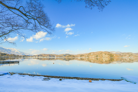 Beautiful fresh snow in winter around the mountains  Lake ,and tree  with blue sky  background, Nagano Prefecture, Japan.の写真素材