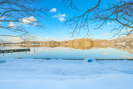 Beautiful fresh snow in winter around the mountains  Lake ,and tree  with blue sky  background, Nagano Prefecture, Japan.の写真素材