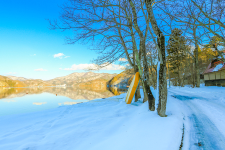Beautiful fresh snow in winter around the mountains  Lake ,and tree  with blue sky  background, Nagano Prefecture, Japan.の写真素材