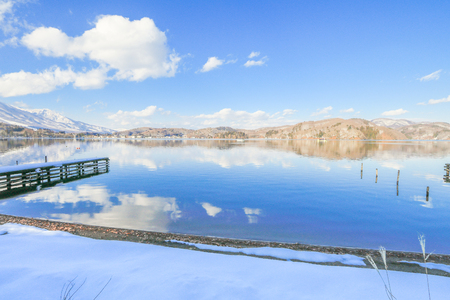 Beautiful fresh snow in winter around the mountains  Lake  with blue sky  background, Nagano Prefecture, Japan.の写真素材