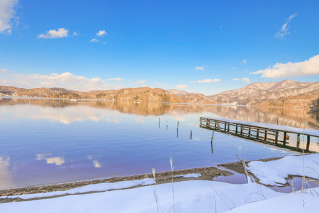 Beautiful fresh snow in winter around the mountains  Lake  with blue sky  background, Nagano Prefecture, Japan.の写真素材