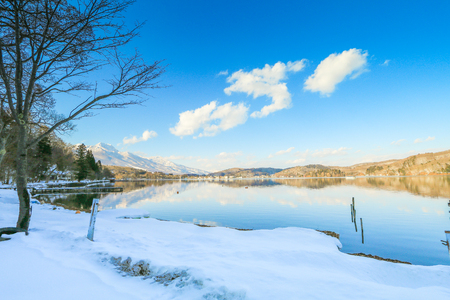 Beautiful fresh snow in winter around the mountains  Lake ,and tree  with blue sky  background, Nagano Prefecture, Japan.の写真素材