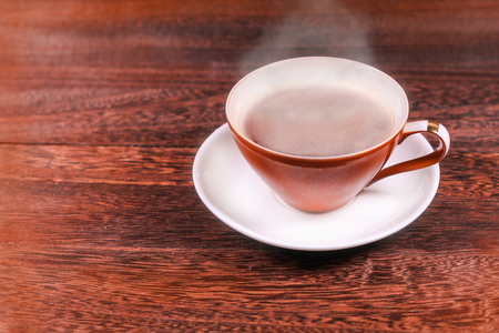 Cup of black coffee on wooden background with copy space .の写真素材
