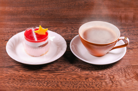 Cup of black coffee and Cake with jelly cream on wooden background with copy space .の写真素材