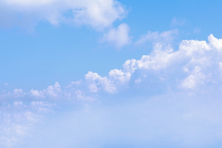 Clear blue sky background with white clouds.の写真素材