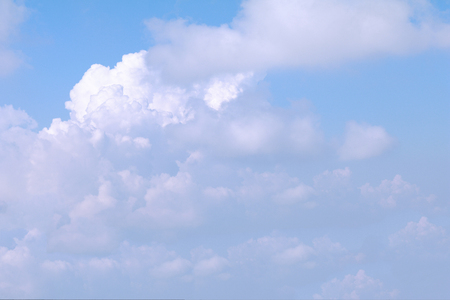 Clear blue sky background with white clouds.の写真素材