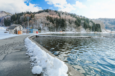 Beautiful fresh snow in winter around the mountains  Lake with blue sky  background, Nagano Prefecture, Japan.の写真素材