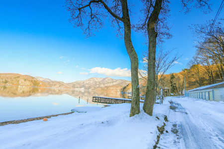Beautiful fresh snow in winter around the mountains  Lake and tree  with blue sky  background, Nagano Prefecture, Japan.の写真素材