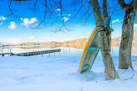 Beautiful fresh snow in winter around the mountains  Lake ,and tree  ,boat with blue sky  background, Nagano Prefecture, Japan.の写真素材