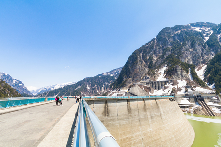 TOYAMA , JAPAN - April 30, 2017:Kurobe Dam on the Kurobe River and beautiful landscape Tateyama Kurobe Alpine Route the snow mountains  with blue sky background in Toyama Prefecture, Japan.のeditorial素材