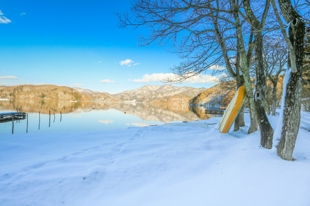 Beautiful fresh snow in winter around the mountains  Lake ,and tree  with blue sky  background, Nagano Prefecture, Japan.の写真素材