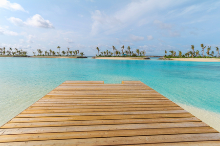 Amazing island in the Maldives ,Beautiful turquoise waters ,wooden bridge with  blue sky  background for holiday vacation .の写真素材