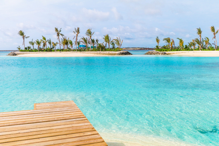 Amazing island in the Maldives ,Beautiful turquoise waters and white sandy beach with  blue sky  background for holiday vacation .の写真素材