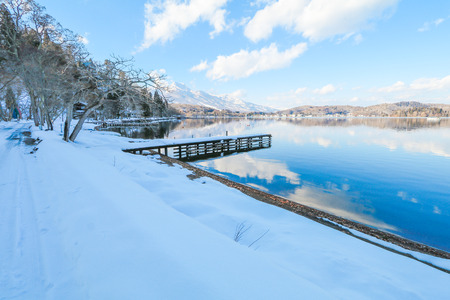 Beautiful fresh snow in winter around the mountains  Lake  with blue sky  background, Nagano Prefecture, Japan.の写真素材
