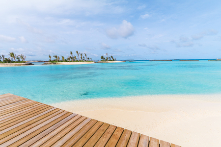 Amazing island in the Maldives ,wooden bridge and  beautiful  turquoise waters with  blue sky  background for holiday vacation .の写真素材