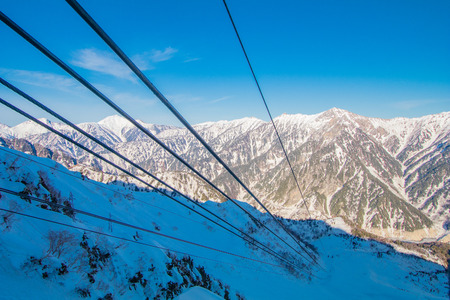 Cable car line of Tateyama Kurobe alpine  in sunshine day with  blue sky background is one of the most important and popular natural place in Toyama Prefecture, Japan.の写真素材