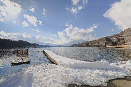 Beautiful fresh snow in winter around the mountains  lake with blue sky  background, Nagano Prefecture, Japan.の写真素材