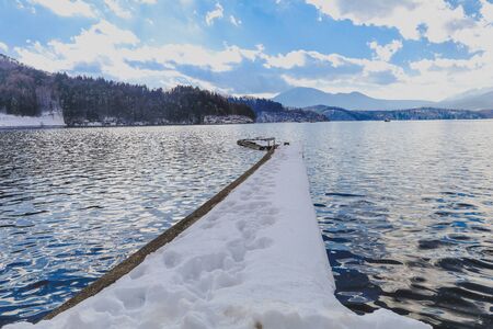 Beautiful fresh snow in winter around the mountains  lake with blue sky  background, Nagano Prefecture, Japan.の写真素材