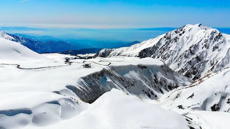 The japan alps  Tateyama Kurobe alpine  in sunshine day with  blue sky background is one of the most important and popular natural place in Toyama Prefecture, Japan.の写真素材