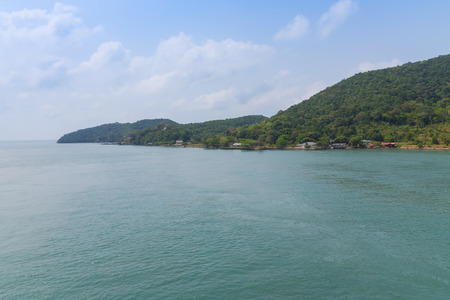 green sea with mountian and blue skyの写真素材