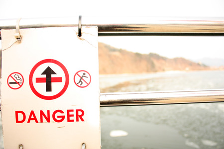 Warning label on the backgroud of lakeの写真素材
