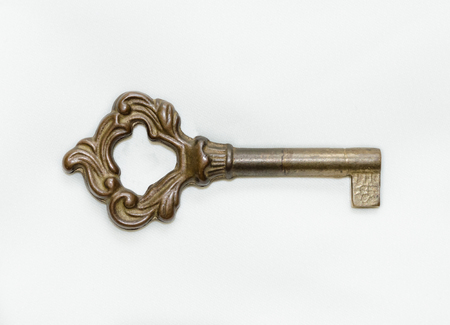 Antique key isolated on white backgroundの写真素材